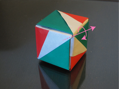 A cube with a single axis of rotation drawn in. This axis of rotation goes through the vertex facing the camera.