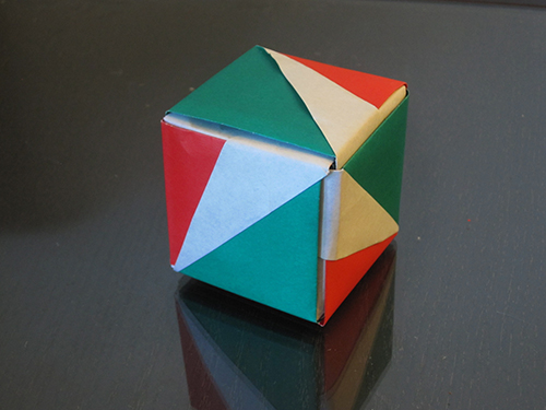 A cube. Three faces are showing, and they're colored in a symmetrical way so that the faces can be rotated into each other without changing their colors.