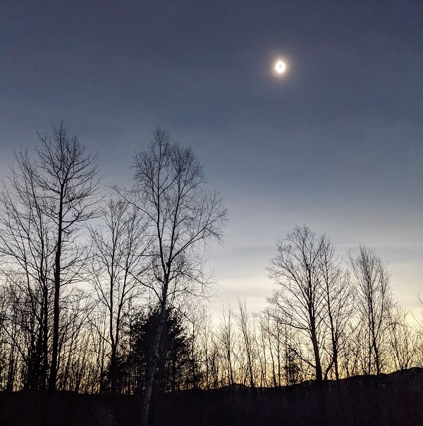 The eclipse at the moment of totality, showing the dark sky and the sun as a blurred ring of light