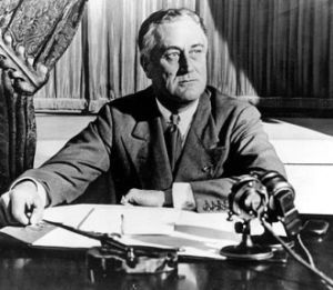President Franklin Roosevelt sitting at a desk
