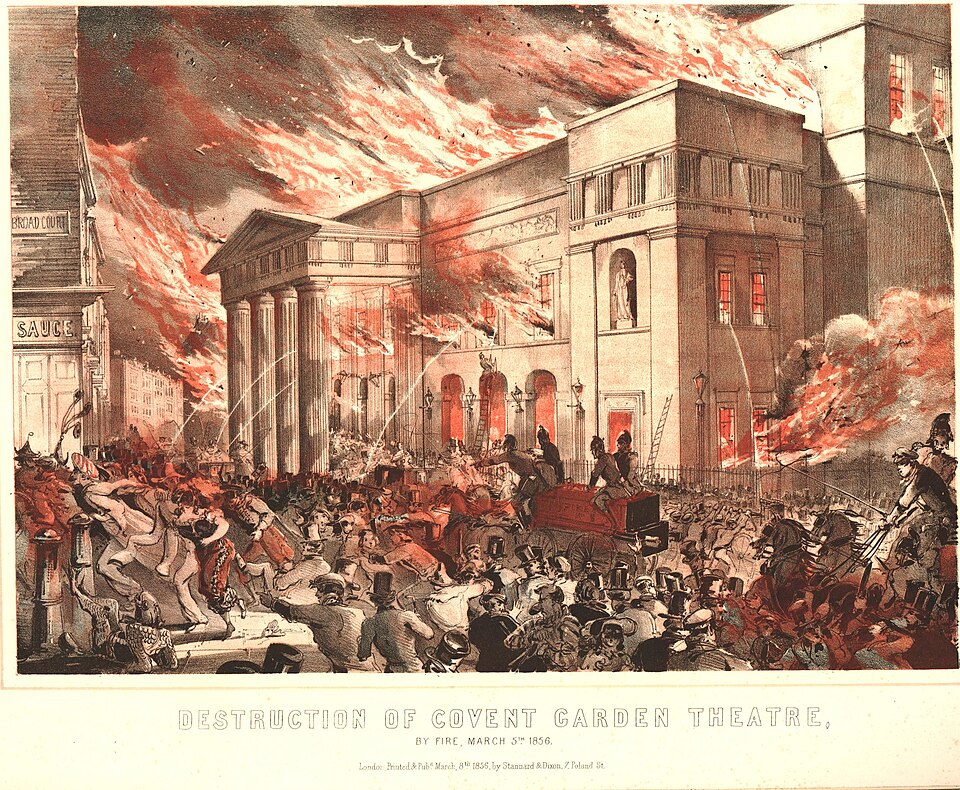 A poster showing a theater engulfed in flames