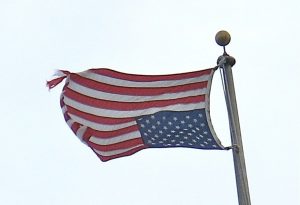 An American flag flies in the inverted position to signal distress.