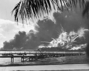 Black and white photo of the USS Shaw being destroyed at the 1941 Japanese attack on Pearl Harbor