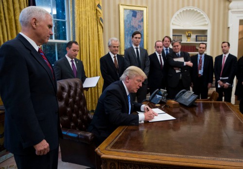 Trump & a gaggle of old white men sign a ban on giving federal family planning funding to international health groups that provide abortion care