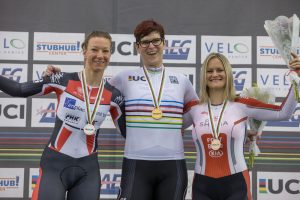 Rachel McKinnon sharing a podium with two other women athletes. Photo by Mike Gladu.