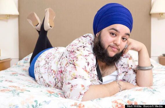 A photo of Harnaam Kaur, showing off her luxurious beard and hinting at a non-trivial amount of dark chest hair.