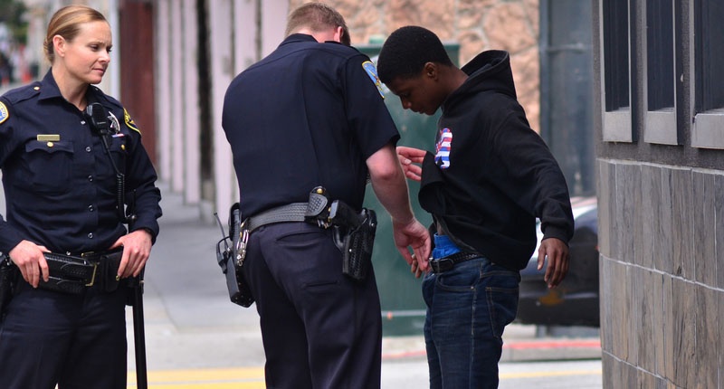 Cops looking at a black guy's underpants