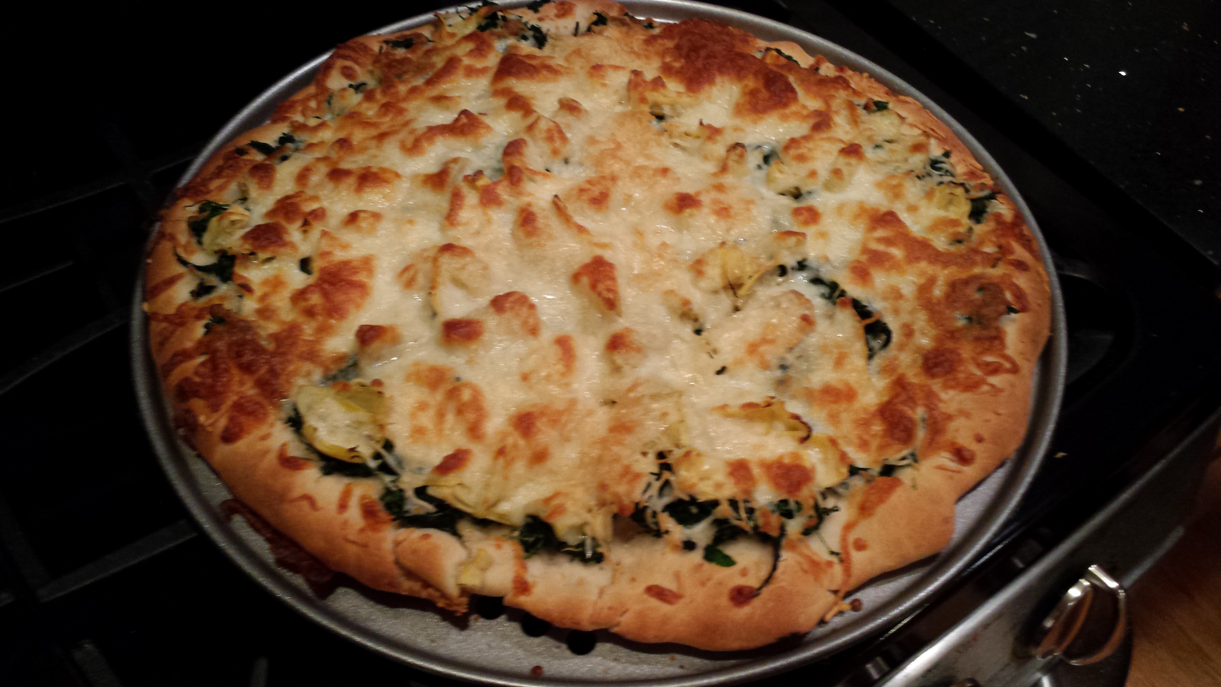 Pizza by commentariat member Celeste: Spinach, artichokes, mozarella, parmesan, forgot the garlic